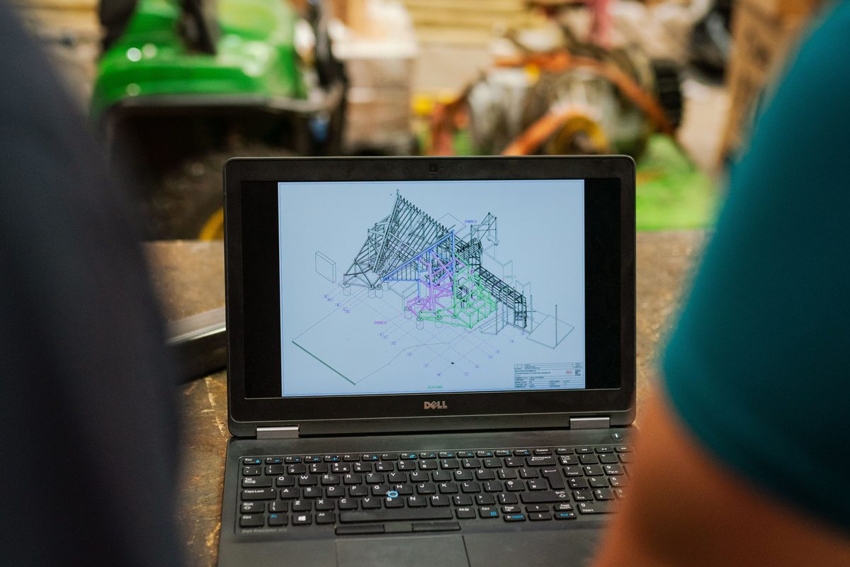 Structural steel frame model reviewed on a laptop before FEA simulation